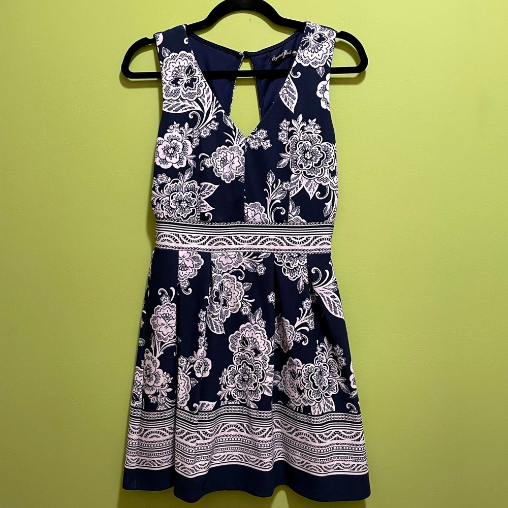 Blue dress with white floral pattern. Size s with open back. A line